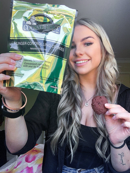 Lady smiling holding cookies